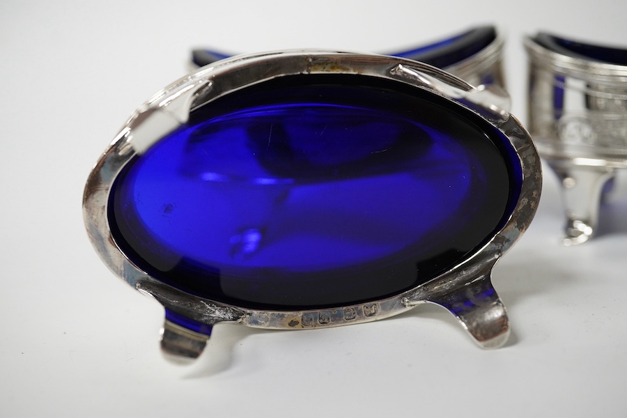 A set of four George III silver oval salts (a.f.) with blue glass liners, London, 1800, 83mm. Condition - poor